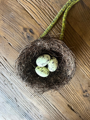 A rope threaded through the wire inside a Feck Off Birds replica seagull nest, ready to tie onto a boat